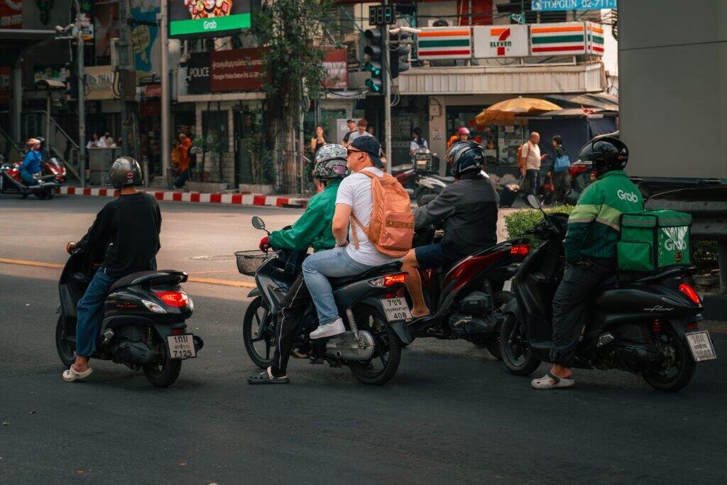 Motorbike riders waiting at a traffic light in Bangkok