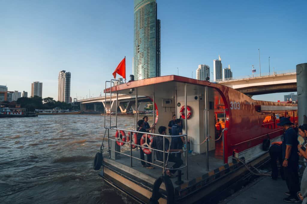 Passengers boarding a Chao Phraya River boat at the pier