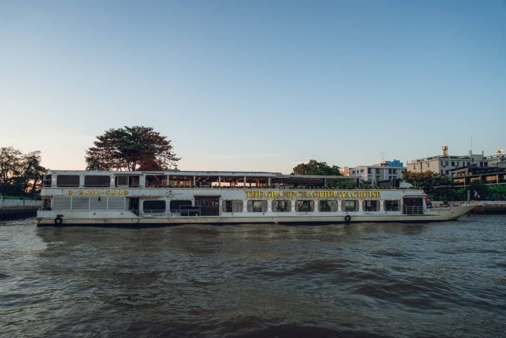 Large dinner cruise boat traveling along the Chao Phraya River in Bangkok