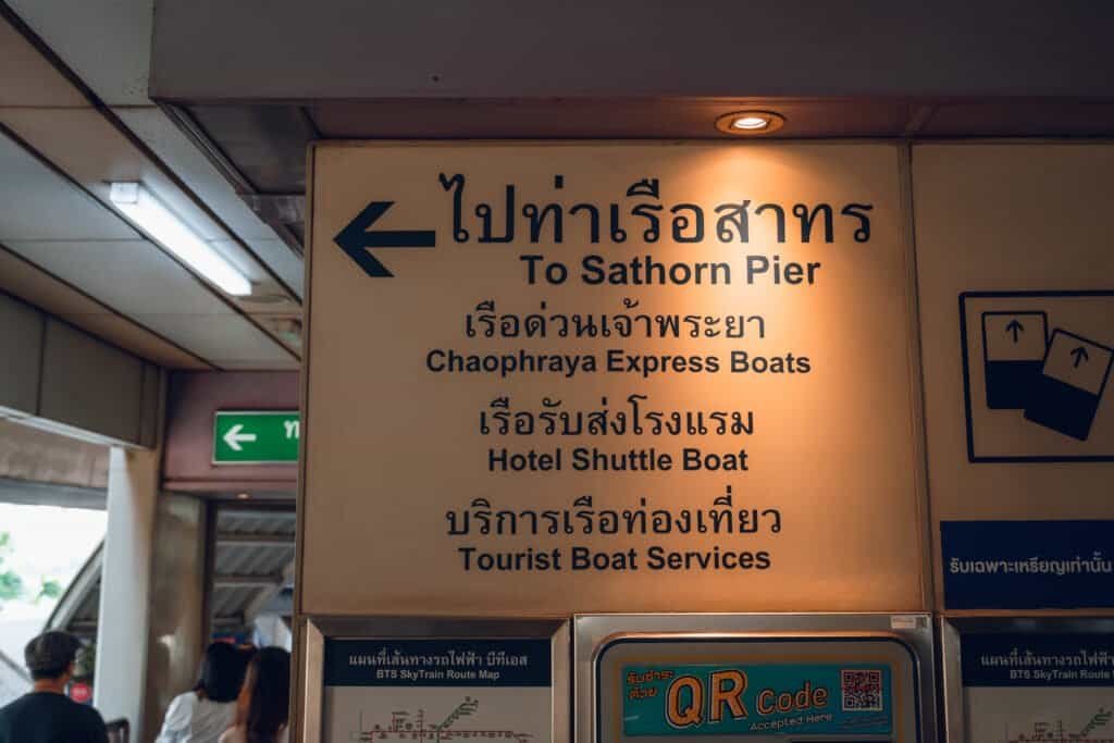 Directional sign pointing to Sathorn Pier and Chao Phraya Express Boats