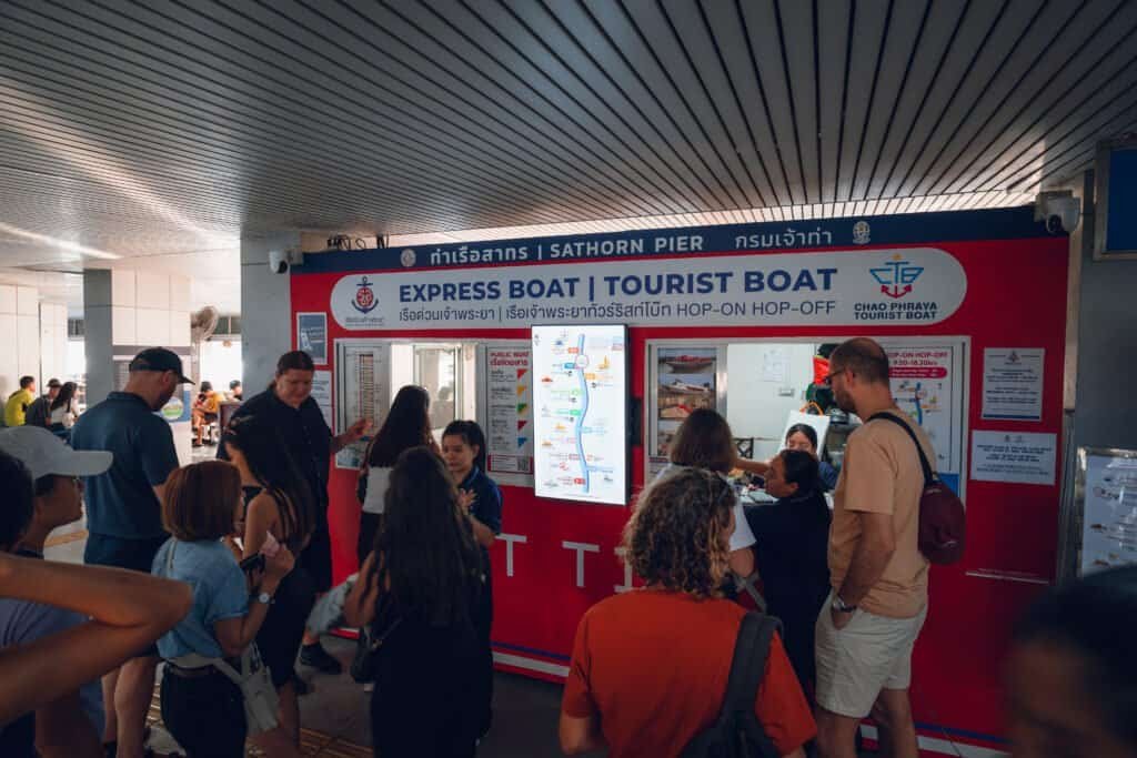 People lining up at the ticket counter at Sathorn Pier in Bangkok