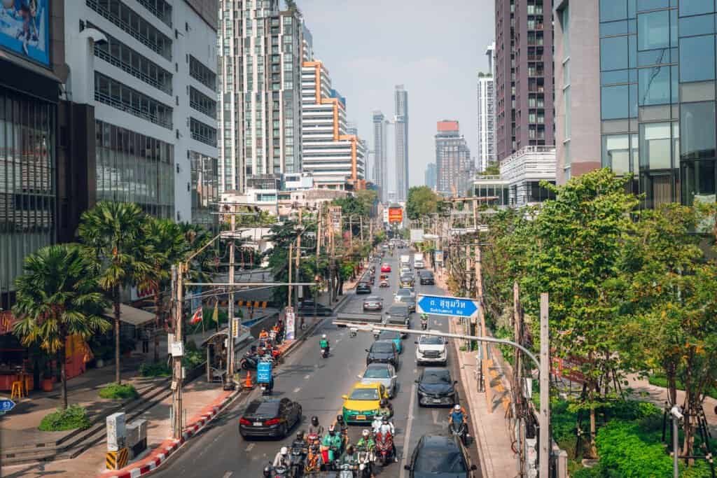 Traffic and motorbikes on Sukhumvit Road in Bangkok during the day